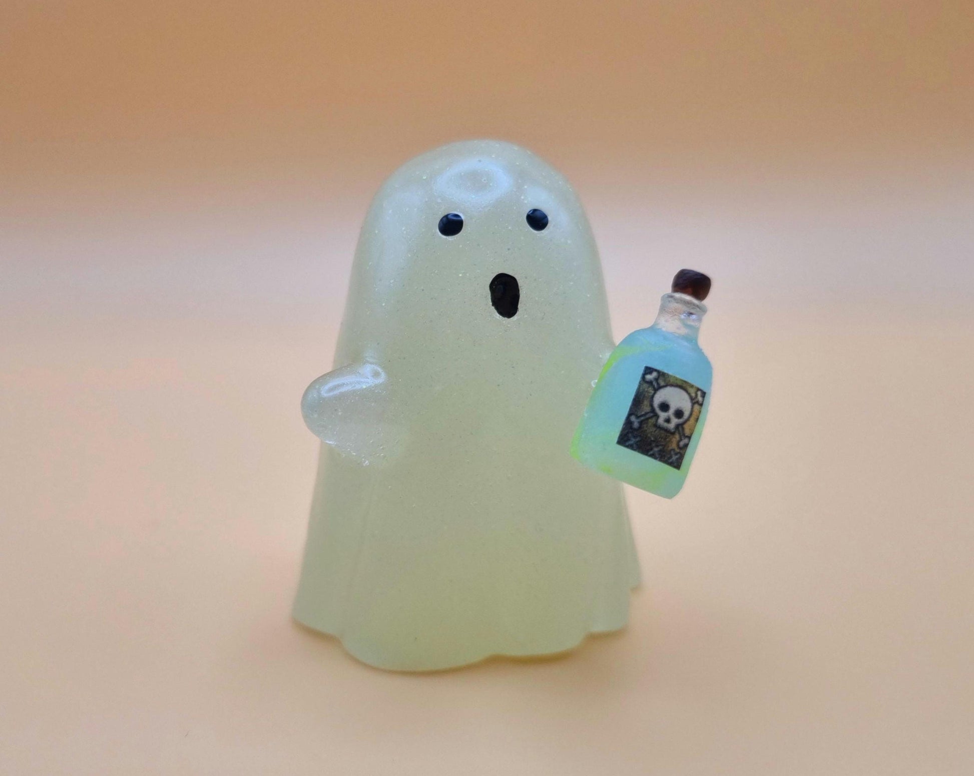 Cute night glow ghost with little blue and green poison bottle with skull on it on orange background 